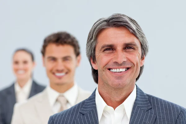 Self-assured businessman and his team — Stock Photo, Image