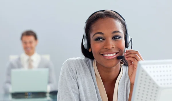 Radiant businesswoman using headset at her desk — Stock Photo, Image