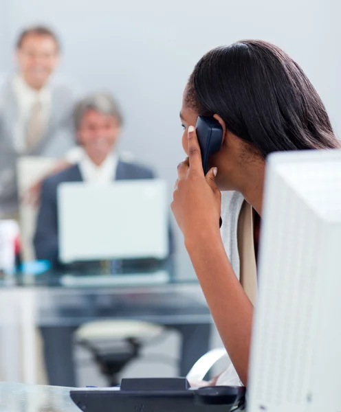Afro-american businesswoman on phone at her desk — Stock Photo, Image
