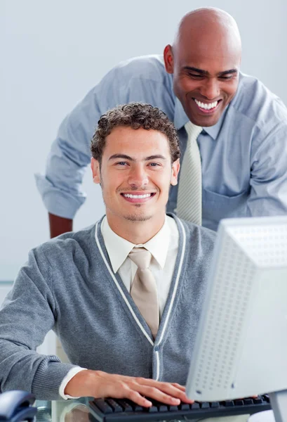 Два привлекательных бизнесмена, работающие за компьютером — стоковое фото