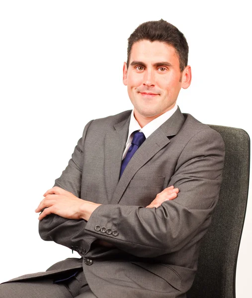 Confident businessman relaxing on a chair — Stock Photo, Image