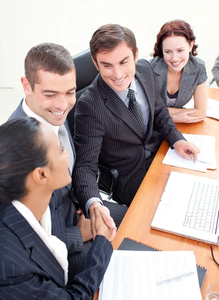 Business team in a meeting shaking hands — Stock Photo, Image