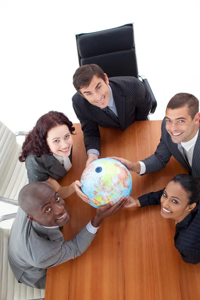 High Angle of smiling team holding a globe. Global business — Stock Photo, Image