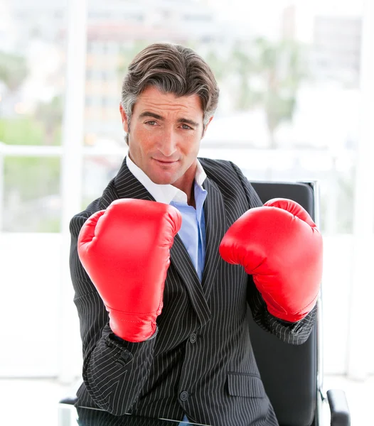 Self-assured businessman wearing boxing gloves — Stock Photo, Image