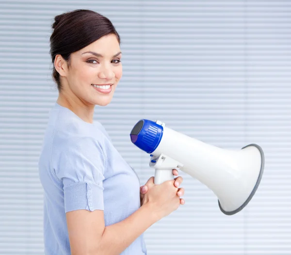 Smiling businesswoman holding a megaphone — Stock Photo, Image
