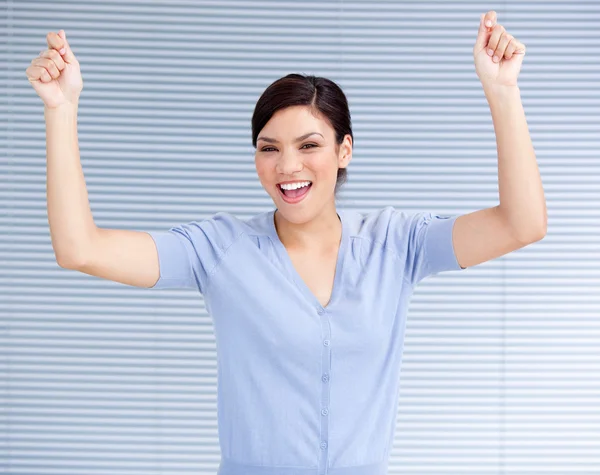 Successful businesswoman punching the air in celebration — Stock Photo, Image