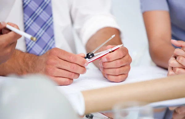 stock image Close-up of architects studying blueprints