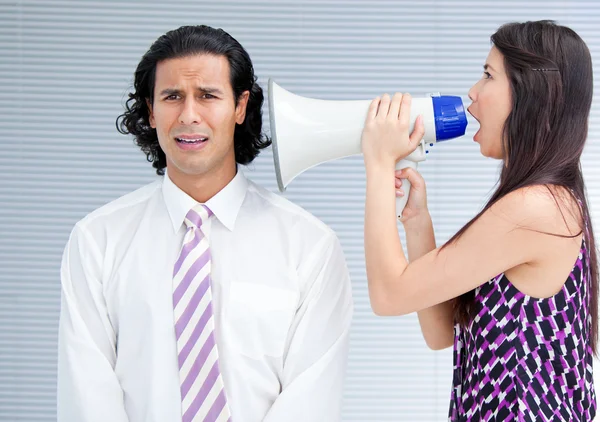 Angry businesswoman yelling through a megaphone — Stock Photo, Image