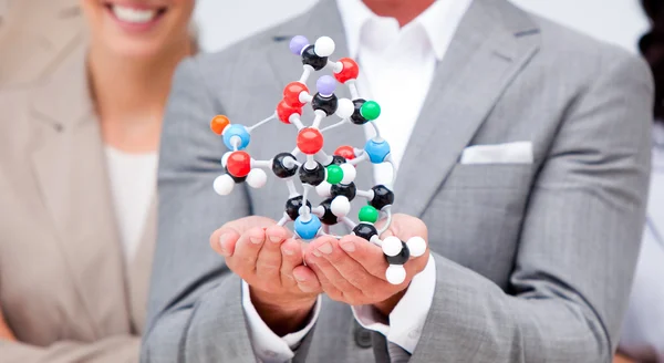 Close-up of a businessman holding a molecule — Stock Photo, Image