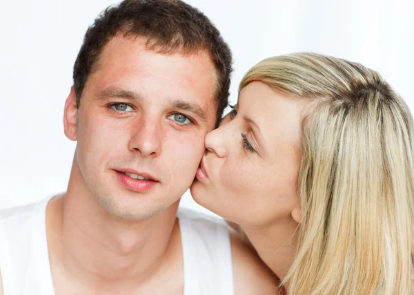 Woman kissing a handsome man — Stock Photo, Image