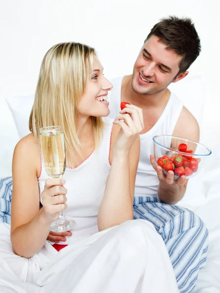 Lovers celebrating an engagement with strawberries and champagne — Stock Photo, Image