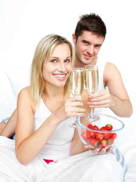 Couple toasting with champagne and strawberries to an engagement — Stock Photo, Image