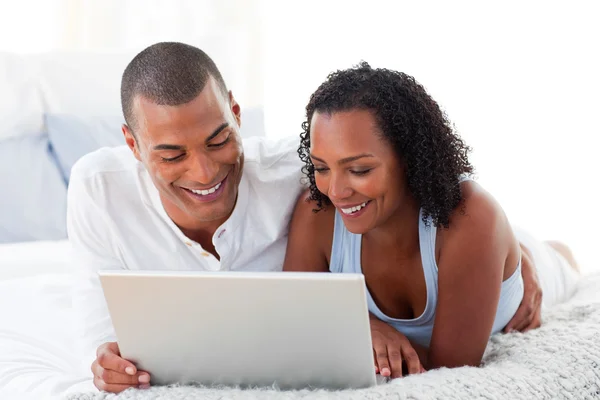 Affectionate couple using a laptop — Stock Photo, Image