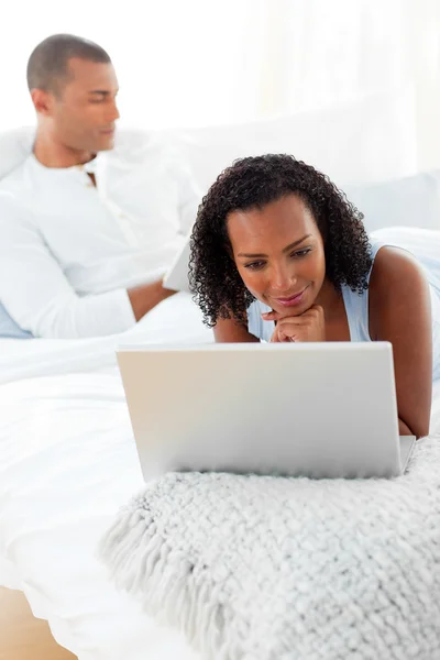 Afro-american couple relaxing on their bed — Stock Photo, Image
