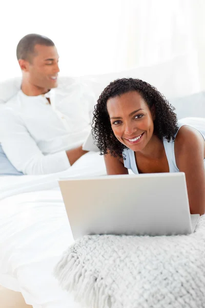 Smiling couple relaxing on their bed — Stock Photo, Image