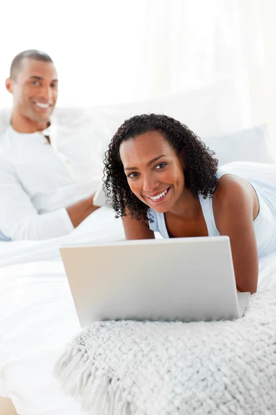 Cheerful couple relaxing on their bed — Stock Photo, Image