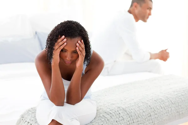 Upset Afro-american couple sitting on bed separately — Stock Photo, Image