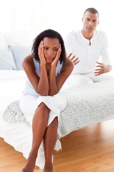 Angry couple sitting on the bed — Stock Photo, Image