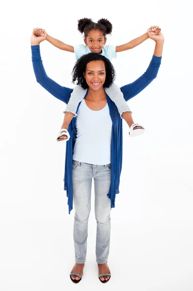 Mother giving happy daughter piggyback ride — Stock Photo, Image