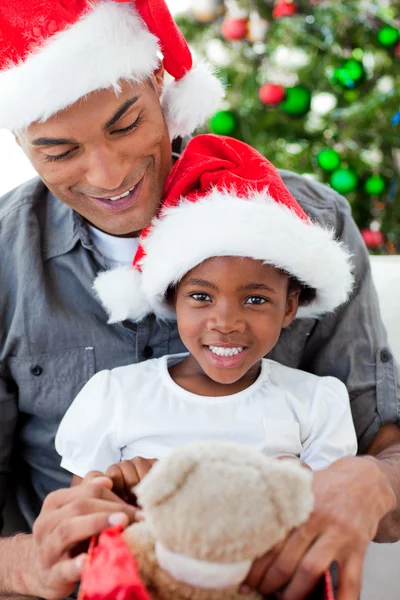 Feliz niña jugando con un regalo de Navidad con su padre —  Fotos de Stock