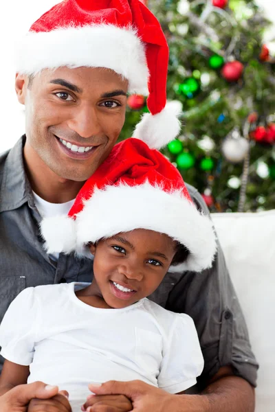 アフリカ系アメリカ人の父と娘のクリスマス帽子をかぶっています。 — ストック写真