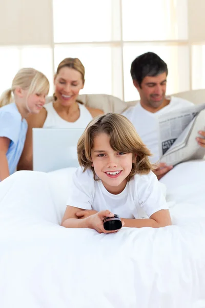 Enthusiastic little boy holding a remote — Stock Photo, Image