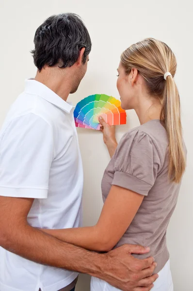 Happy Couple choosing a color with to paint their bedroom — Stock Photo, Image