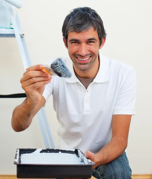 Attractive man painting a wall — Stock Photo, Image