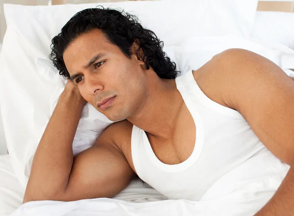 Angry man lying in the bed — Stock Photo, Image