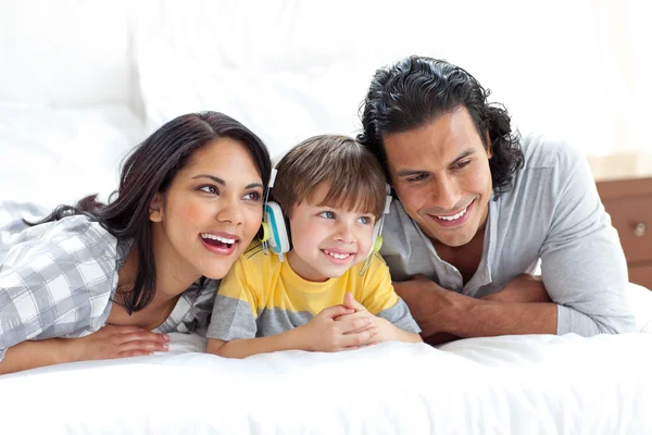 Happy parents listening to music with their son — Stock Photo, Image