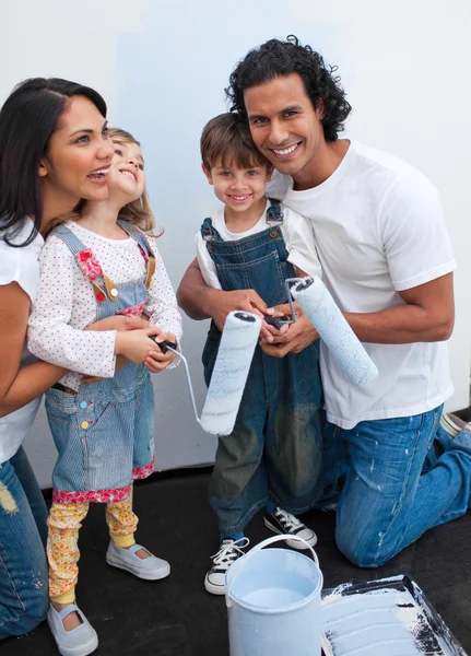 Cute children painting a room with their parents — Stock Photo, Image