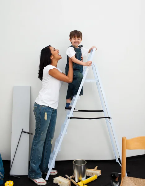 Happy little boy climbing a ladder — Stock Photo, Image