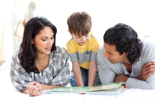 Affectionate family reading book together — Stock Photo, Image