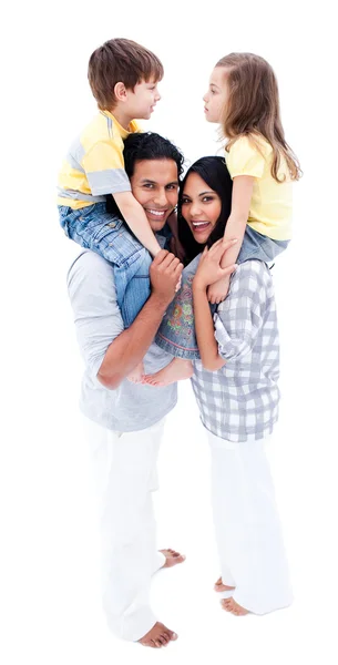 Happy young parents giving piggyback ride to their children — Stock Photo, Image