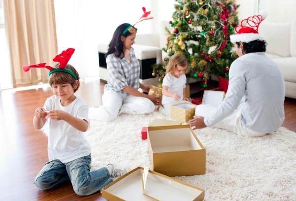 Family playing with Christmas gifts at home — Stok fotoğraf