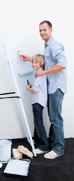 Father and his boy painting a room with brushes — Stock Photo, Image