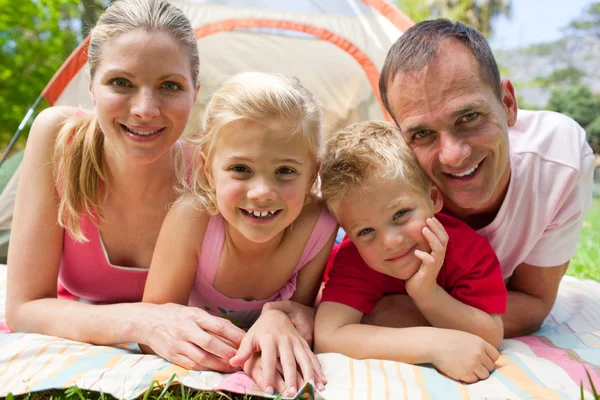Portrait of a happy family lying on the grass — Stock Photo, Image