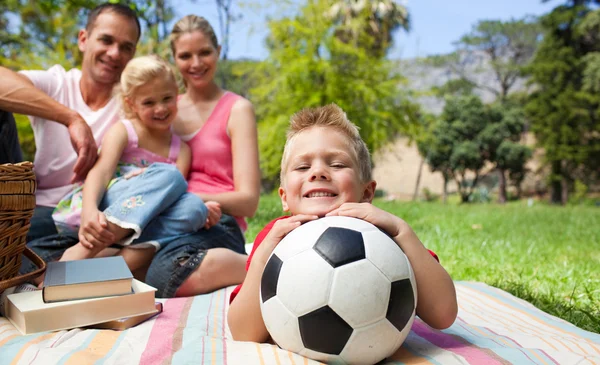 Smiling boy holding a soccer ball — Stock Photo, Image