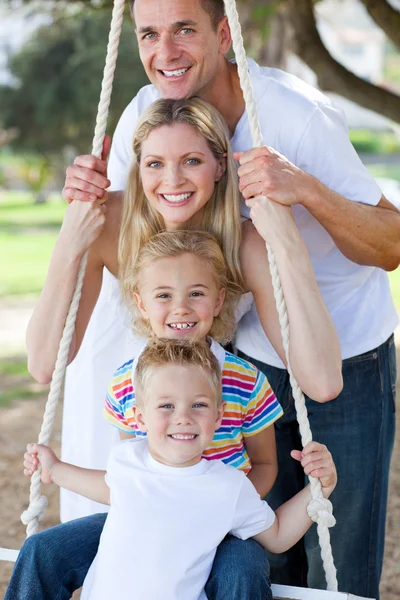 Jolly family swinging — Stock Photo, Image
