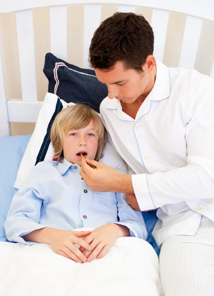 Прихильний батько перевіряє температуру свого сина — стокове фото
