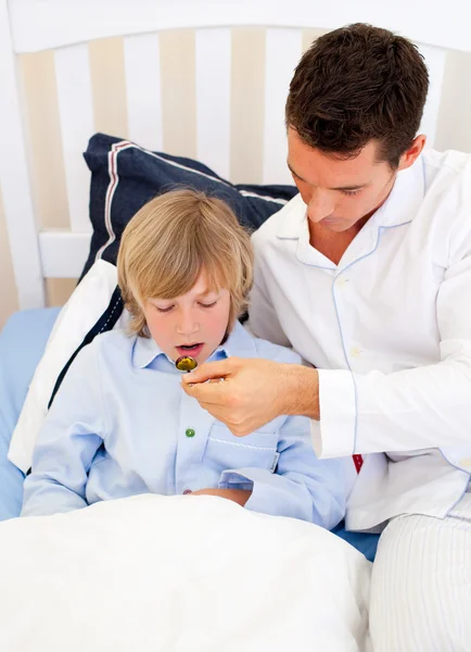 Handsome father checking his son's temperature — Stock Photo, Image