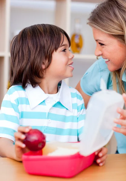 Cute little boy and his mother preparing his snack — Stock Photo, Image