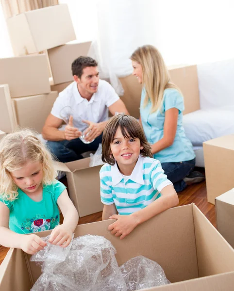 Cheerful family packing boxes — Stock Photo, Image