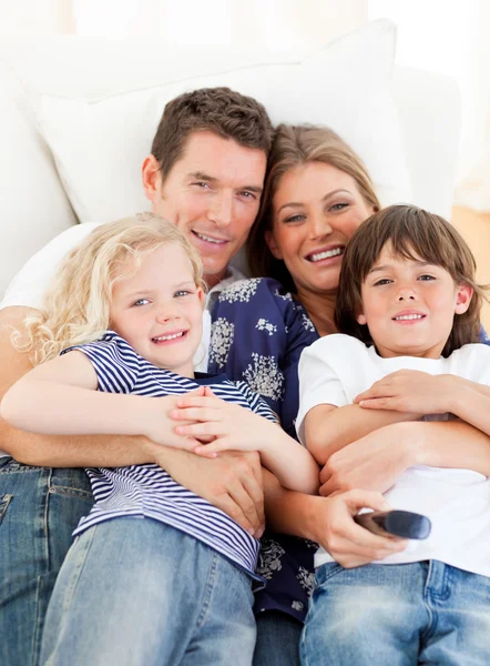 Caucasian family watching television sitting on sofa — Stock Photo, Image