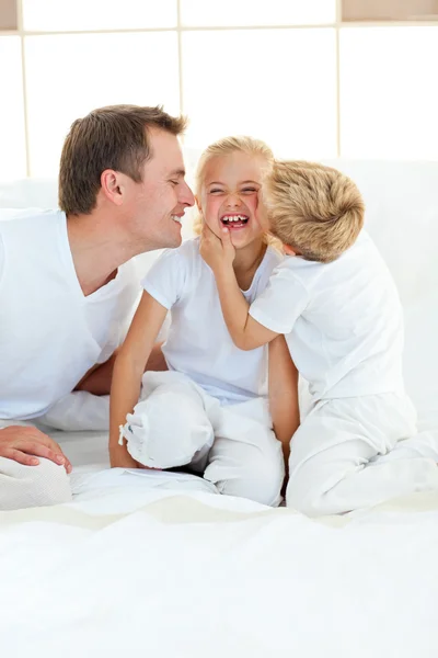 Cute siblings playing with their father — Stock Photo, Image