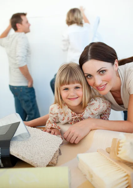 Young family decorating a room — Stock Photo, Image