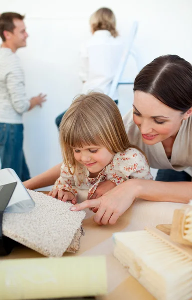 Jolly family decorating a room — Stock Photo, Image