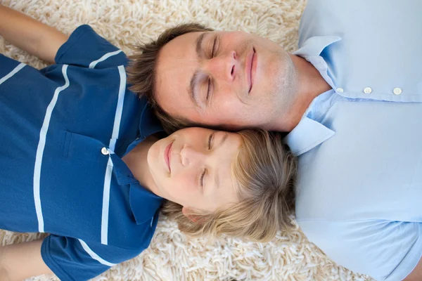 Father and his son lying on the floor — Stock Photo, Image