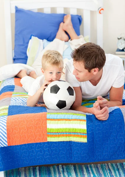 Adorable little boy and his father watching a football match — Stock Photo, Image