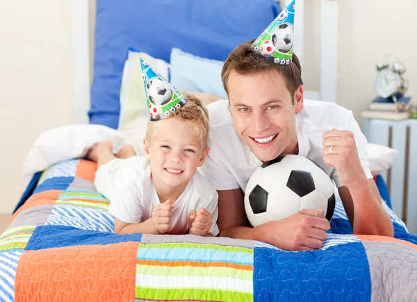 Cute little boy and his father watching a football match — Stock Photo, Image